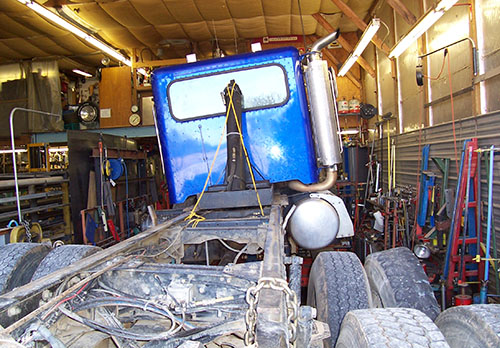 Blue truck with uneven bed